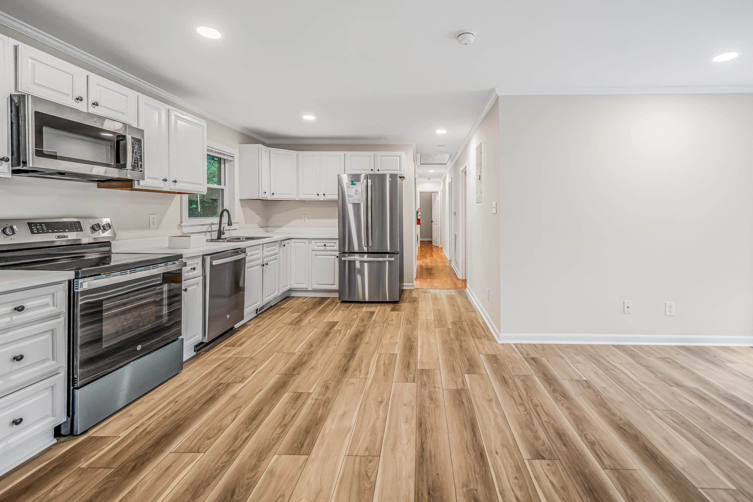 Open kitchen and living area at The Ramsey with wood-look flooring